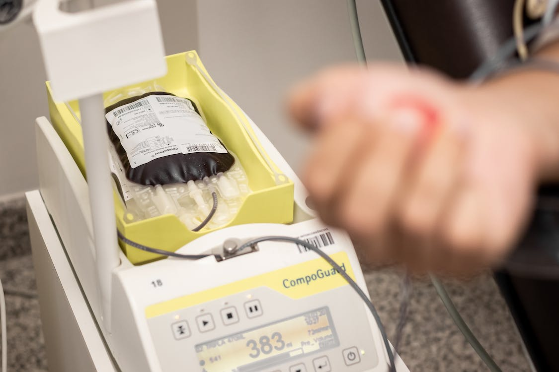 A Blood Collector Filling a Bag with Human Blood 
